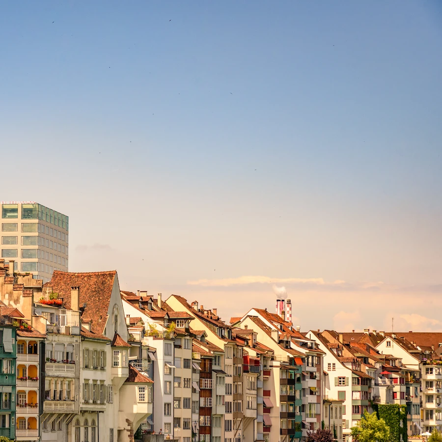 A view of a Swiss city with numerous high-rise apartments. The buildings are modern and well-maintained.
